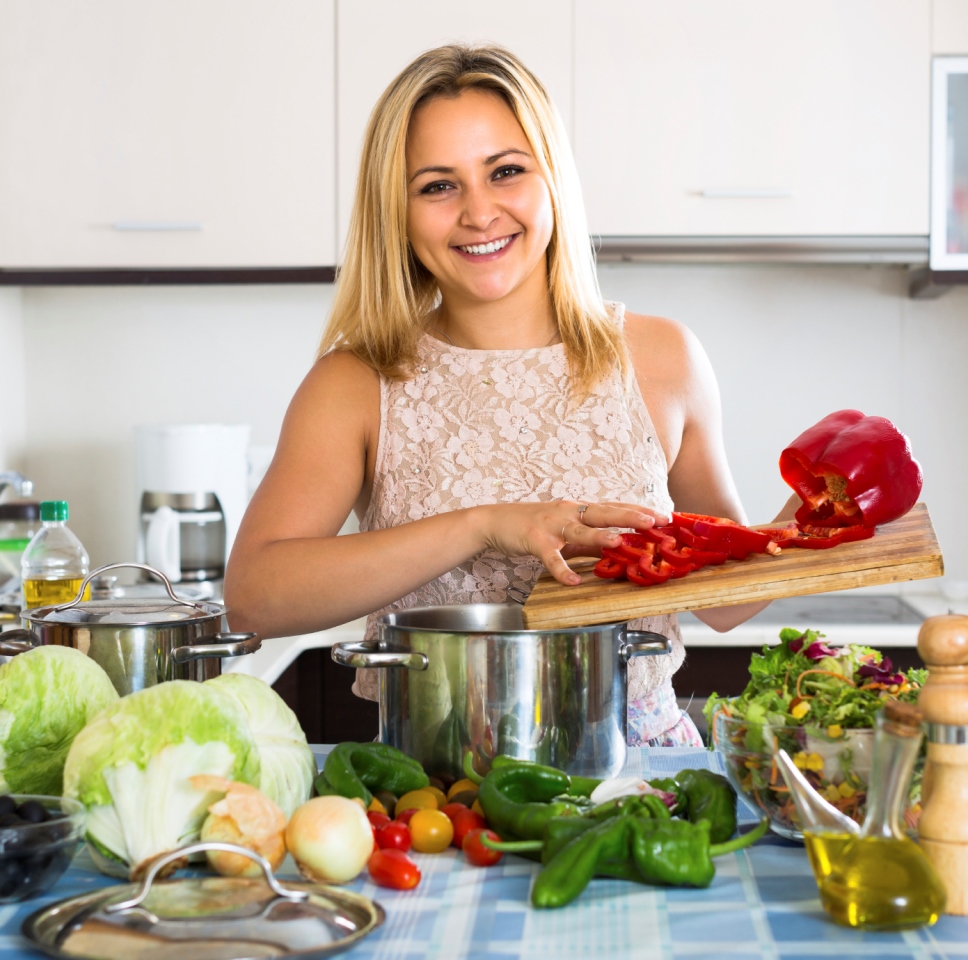 Woman cooking vegetables in kitchen