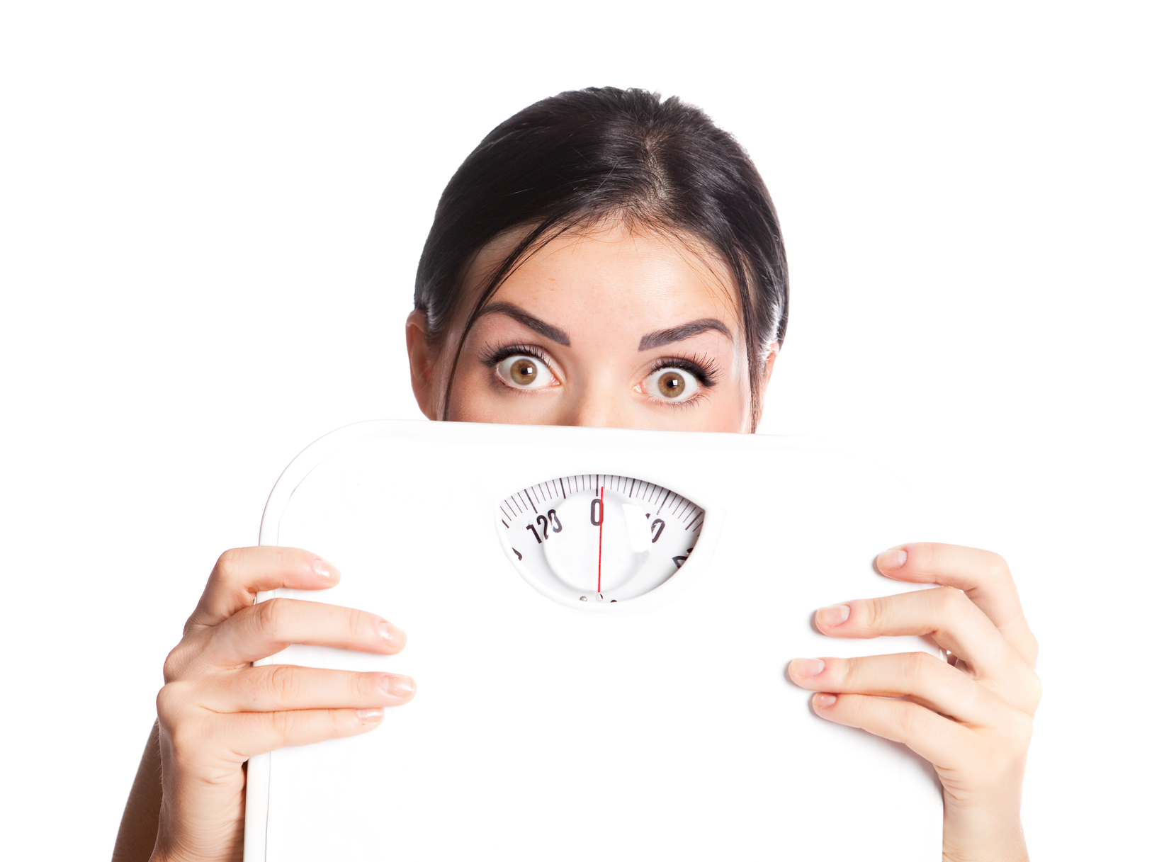 Beautiful young scared  woman  holding scales, isolated against white background